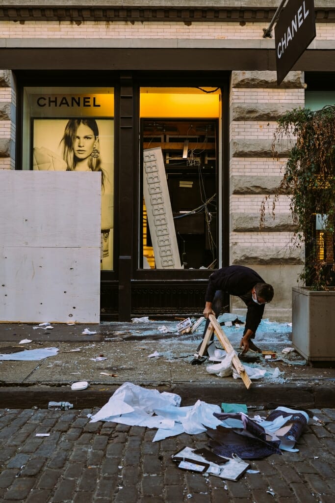 Retailers in Soho clean up the streets after looting after the Black Lives Matter Protests.